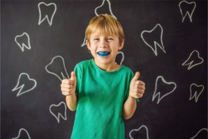 The kid wears a mouth guard.